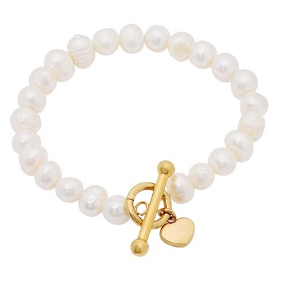 Steeltime Ladies freshewater pearl and stainless steel heart charm stretch bracelet. Color Options: Silver, Gold